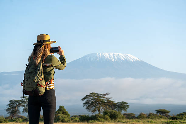 A climber taking a photo of mountain Kilimanjaro